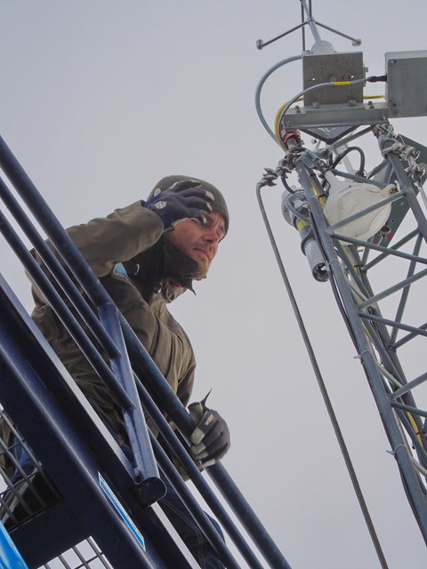 John Prytherch attending to the instruments at top of the mast using the lift mounted behind the mast