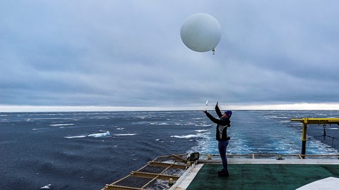 Sonja Murto, Stockholm University, releases a sounding balloon from the helicopter deck