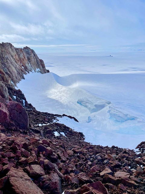 Red rocks against white snow.