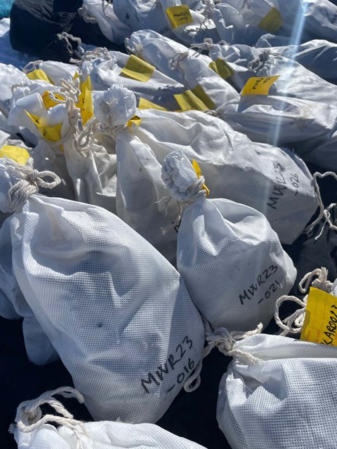 White bags marked with black text and yellow labels.
