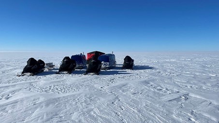 Field camp with arcs and snowmobiles