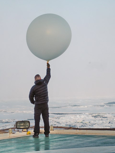 Expeditionens meteorolog Nicke Juuso hjälper till med väderballongerna som släpptes var sjätte timme från helikopterplattan