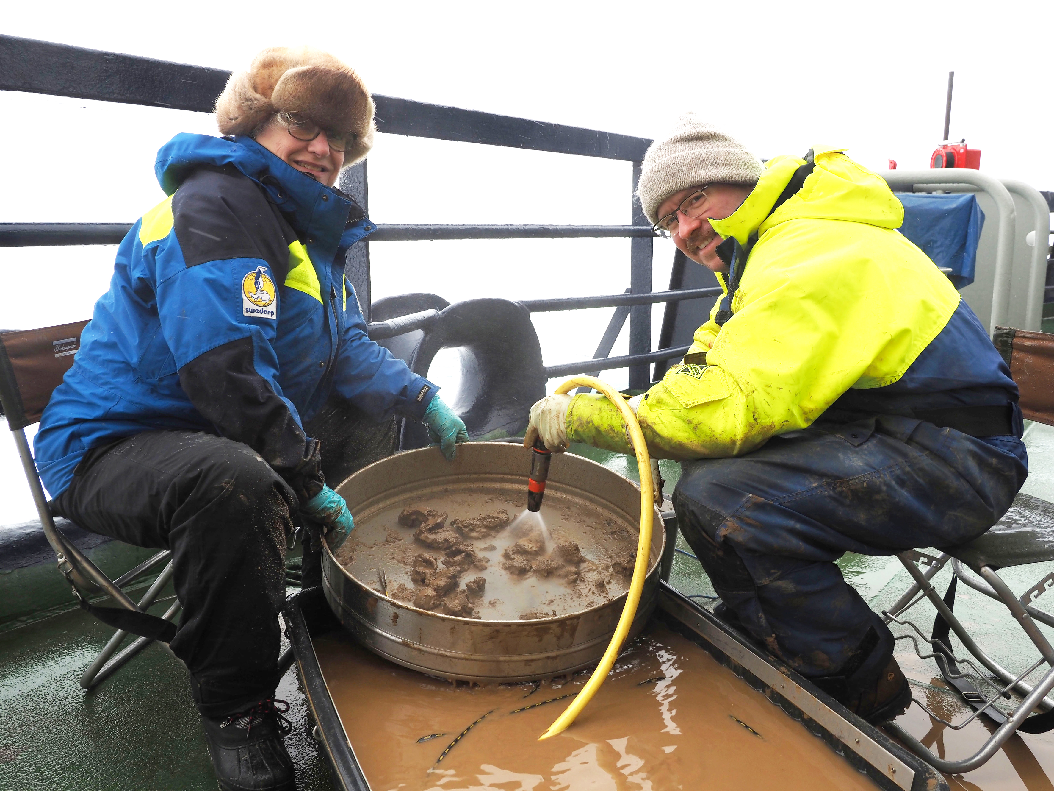 Pauline Snoeijs-Leijonmalm and Julek Chawarski extract otoliths from sediment samples on the deck of the icebreaker Oden