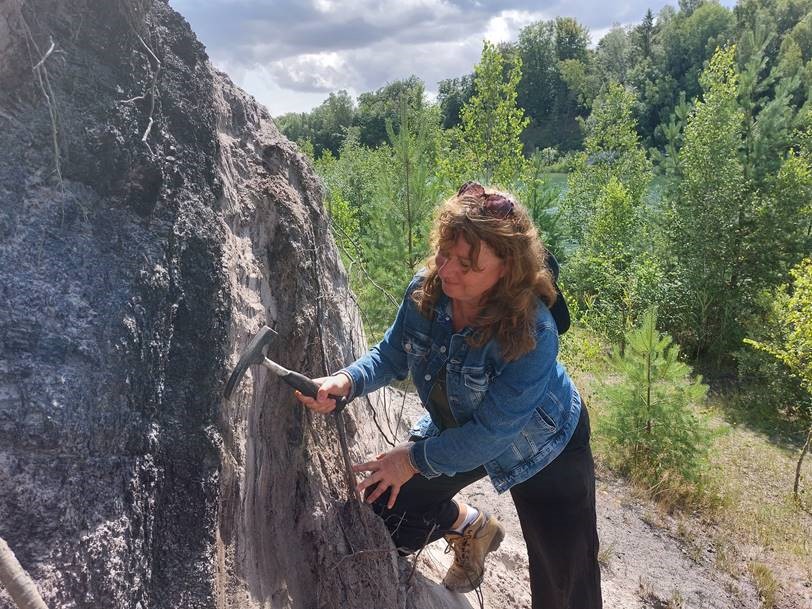 Vivi Vajda conducting geological fieldwork in Fyledalen, Skåne, where she is collecting sediments from the Jurassic period.