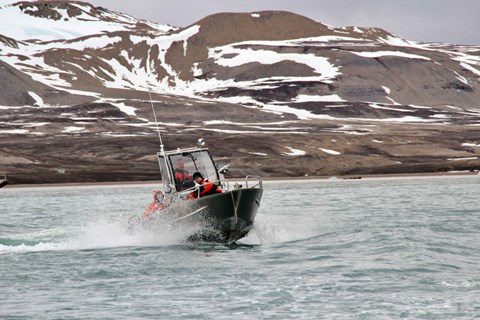 Boat with mountains in the background.